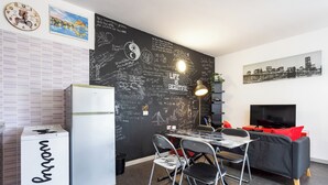 A compact living space with a kitchenette, a dining area, and a seating area. - Home2Book Modern Studio & Pool Costa del Silencio (Arona)