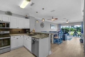 Enjoy meals in this well-equipped kitchen with appliances and a dining area with a table and chairs.