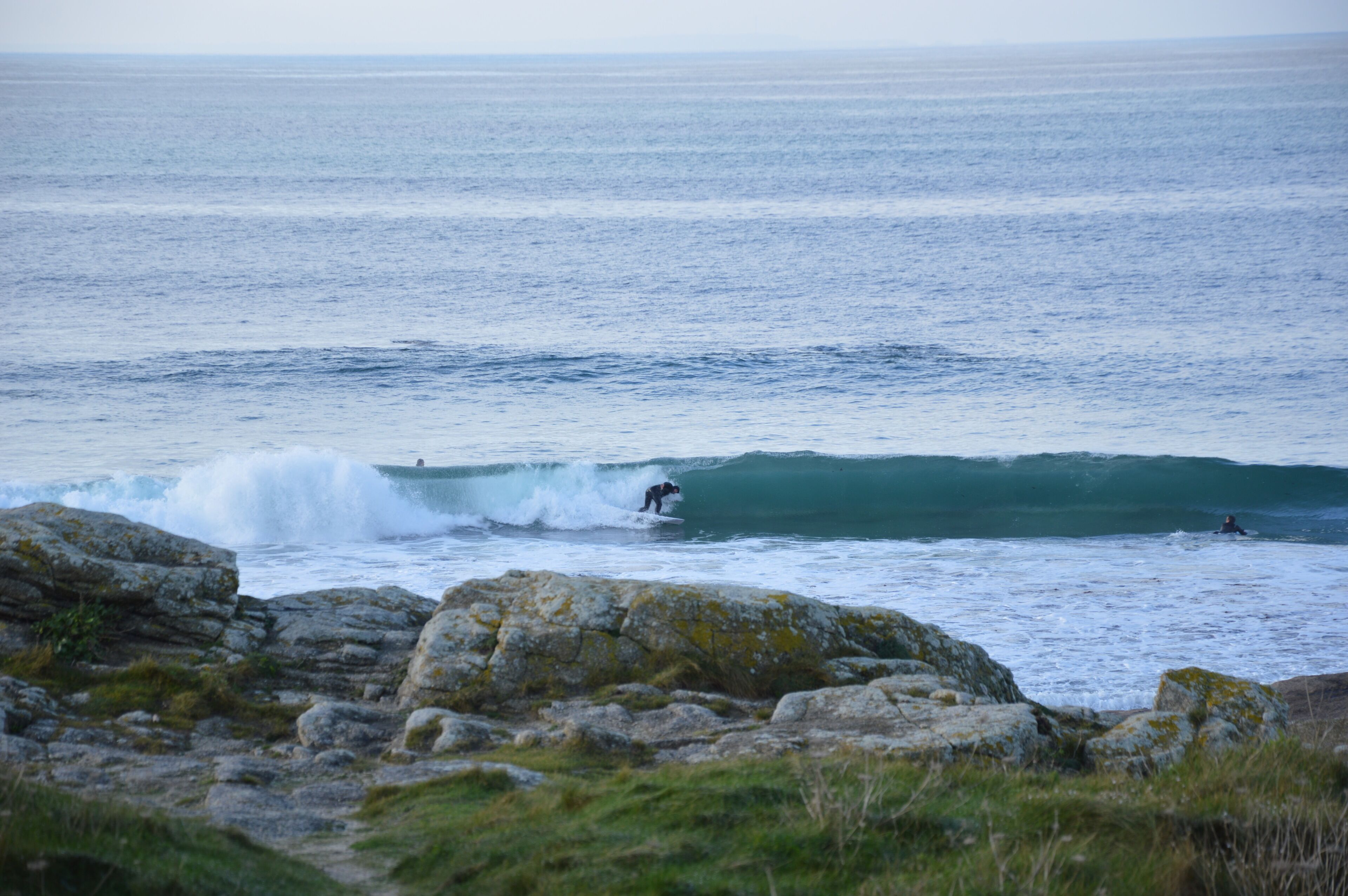 A coastal scene with waves and rocks.