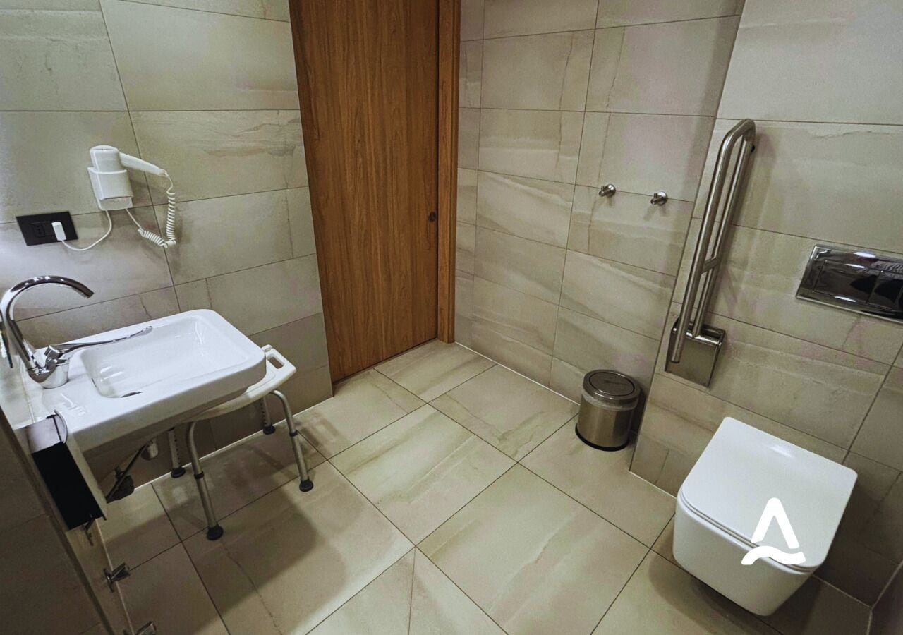 Un baño pequeño con lavamanos, inodoro y ducha.