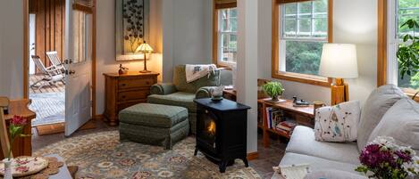 A cozy living room with a fireplace, a sofa, a coffee table, and a rug.