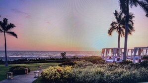 A beachside resort with palm trees, a pool area, and a view of the ocean. -  Vidanta Nuevo Vallarta! (Nuevo Vallarta)