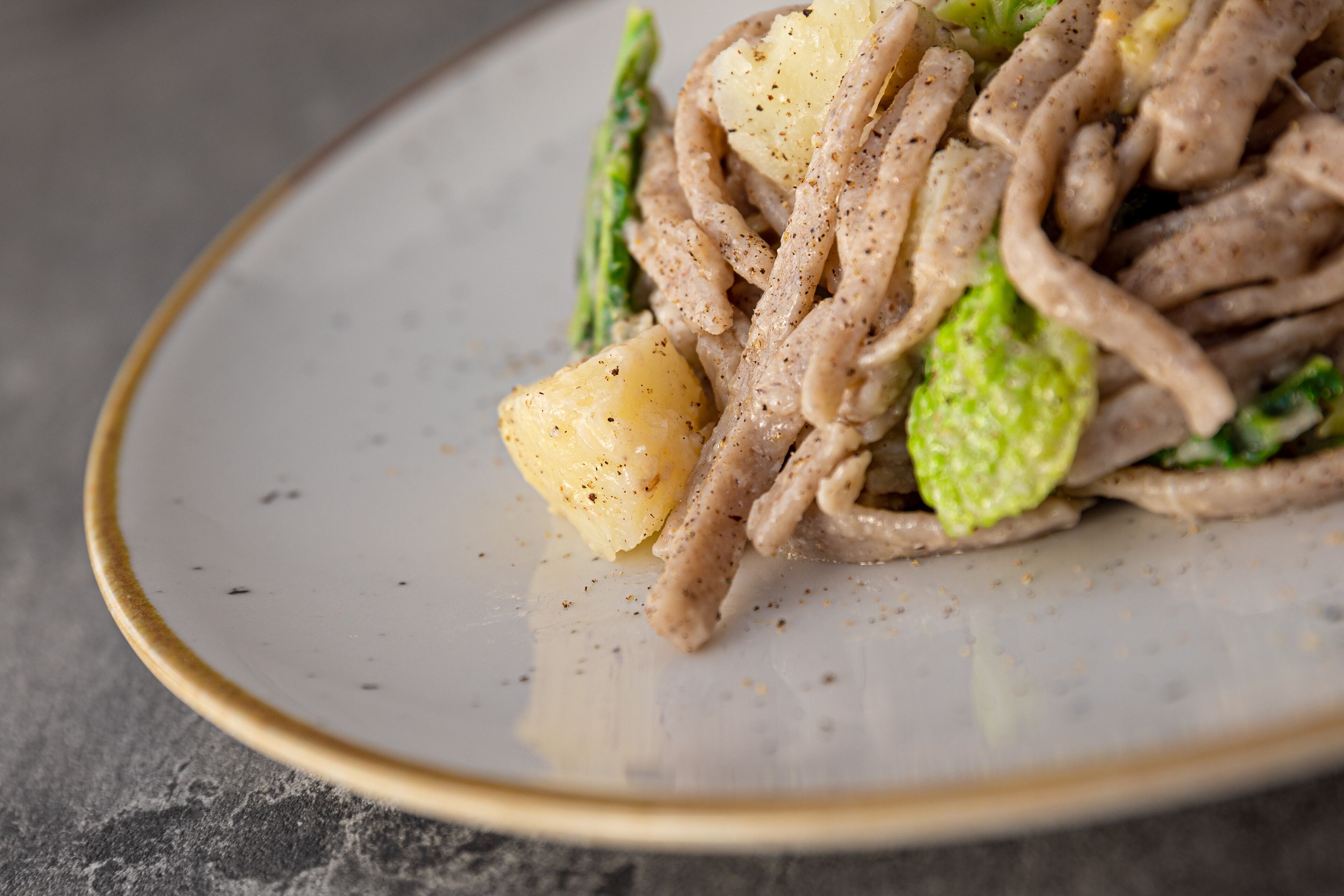 A plate of stir-fried noodles with vegetables and meat.