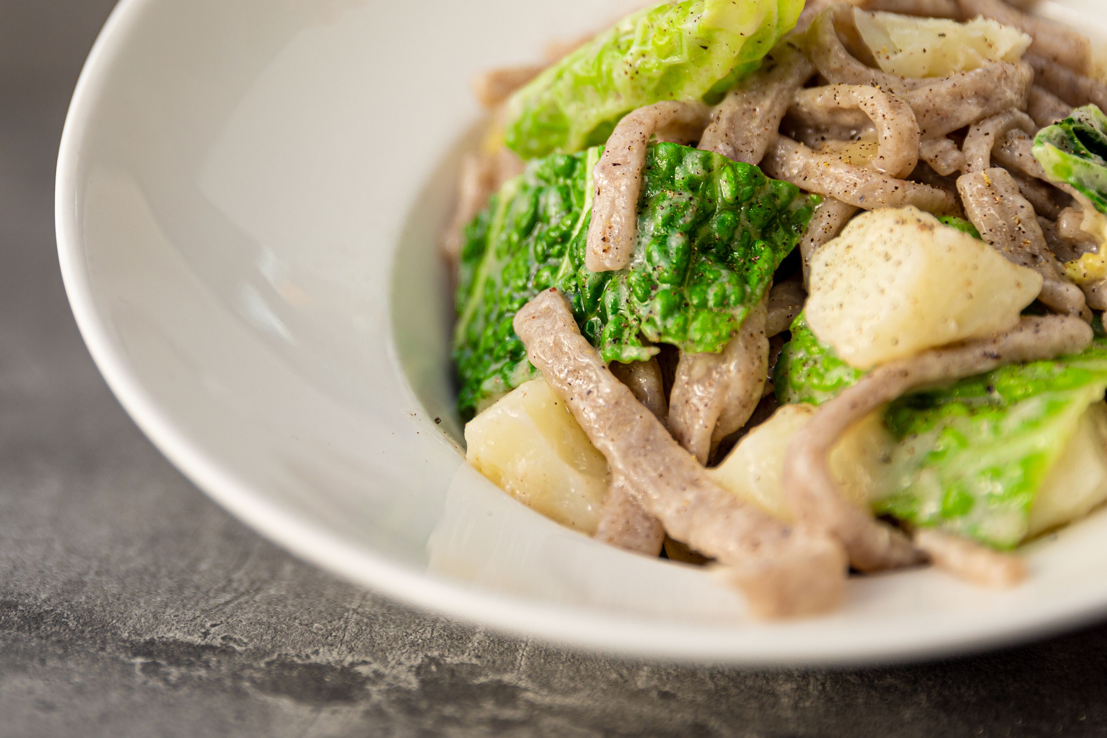 A bowl of stir-fried vegetables and meat.