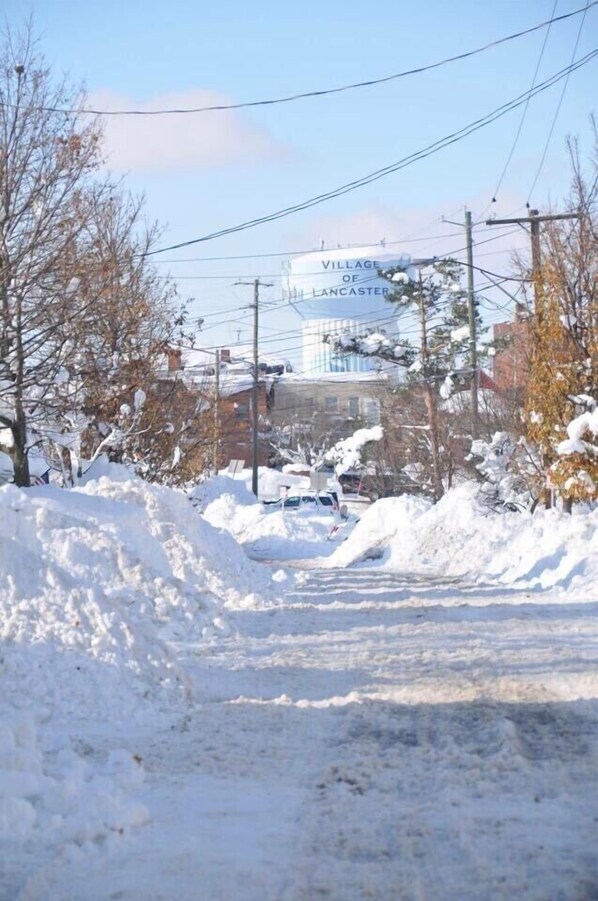 A snow-covered road with a sign for the Village of Lancaster in the background. - Buffalo, NY 3 bedroom village home by carol (Lancaster)
