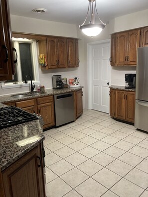 Microwave, dishwasher, coffee/tea maker, cookware/dishes/utensils