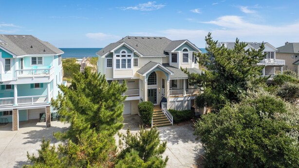 A beachfront property with multiple houses, a covered walkway, and a view of the ocean. - OCEANFRONT, Private Pool, Ocean Views, Shared Beach Walkway, BU10, Summer Paradise (Corolla)