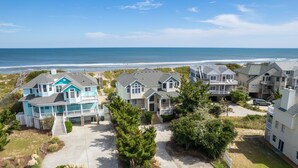 A coastal residential area with houses featuring balconies and a view of the ocean. - OCEANFRONT, Private Pool, Ocean Views, Shared Beach Walkway, BU10, Summer Paradise (Corolla)