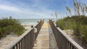 A wooden boardwalk leading to the beach, surrounded by vegetation. - OCEANFRONT, Private Pool, Ocean Views, Shared Beach Walkway, BU10, Summer Paradise (Corolla)