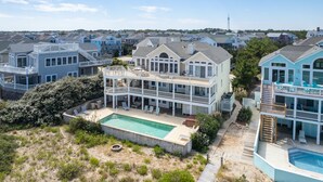 A multi-story residential building with a pool and outdoor seating area. - OCEANFRONT, Private Pool, Ocean Views, Shared Beach Walkway, BU10, Summer Paradise (Corolla)