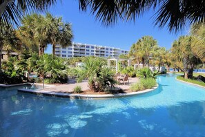 Relax by the resort's serene pool surrounded by lush tropical vegetation and stunning views.