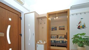 A bedroom with a bed, a bedside table, a wardrobe, and a potted plant. - Holiday home mit Klimaanlage und Terrasse (Vinkuran)