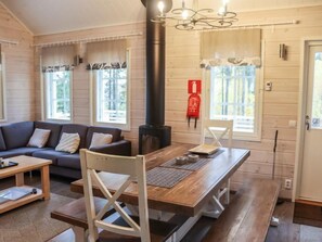 Relax in this stylish room with a comfortable sofa, dining table, and large window.