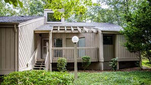 A two-story house with a covered porch, a small front yard, and a visible front door. - 🌄Resort Vacations at Fairfield Glade TN Fabulous Golf Villa, two bedrooms with 4 beds! (Fairfield Glade)