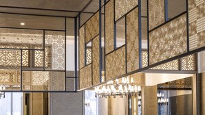 A modern interior with geometric wall panels and a chandelier. - Formosa Yacht Resort (Tainan)