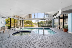 Relax by the central hot tub surrounded by a tiled floor and enjoy the views of the surrounding greenery.