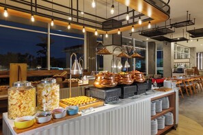A buffet setup with various food items and serving utensils. - fave+ hotel Pamanukan (Pamanukan)