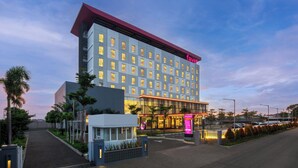 A high-rise hotel with a modern facade, multiple windows, and a prominent entrance. - fave+ hotel Pamanukan (Pamanukan)