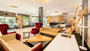 A modern lobby with seating areas, a reception desk, and large windows. - Orka Village Hisarönü (Fethiye)