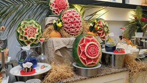 A buffet with various food items and decorative elements. - Orka Village Hisarönü (Fethiye)