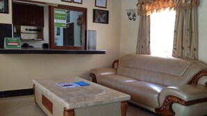 A reception area with a reception desk, a sofa, and a coffee table. - Ceamo Prestige Lodge (Makutano)