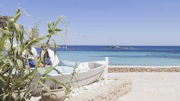 On the beach, white sand, sun-loungers, beach umbrellas