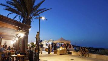 On the beach, white sand, sun loungers, beach umbrellas