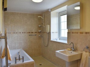 Bathtub, towels, soap, toilet paper