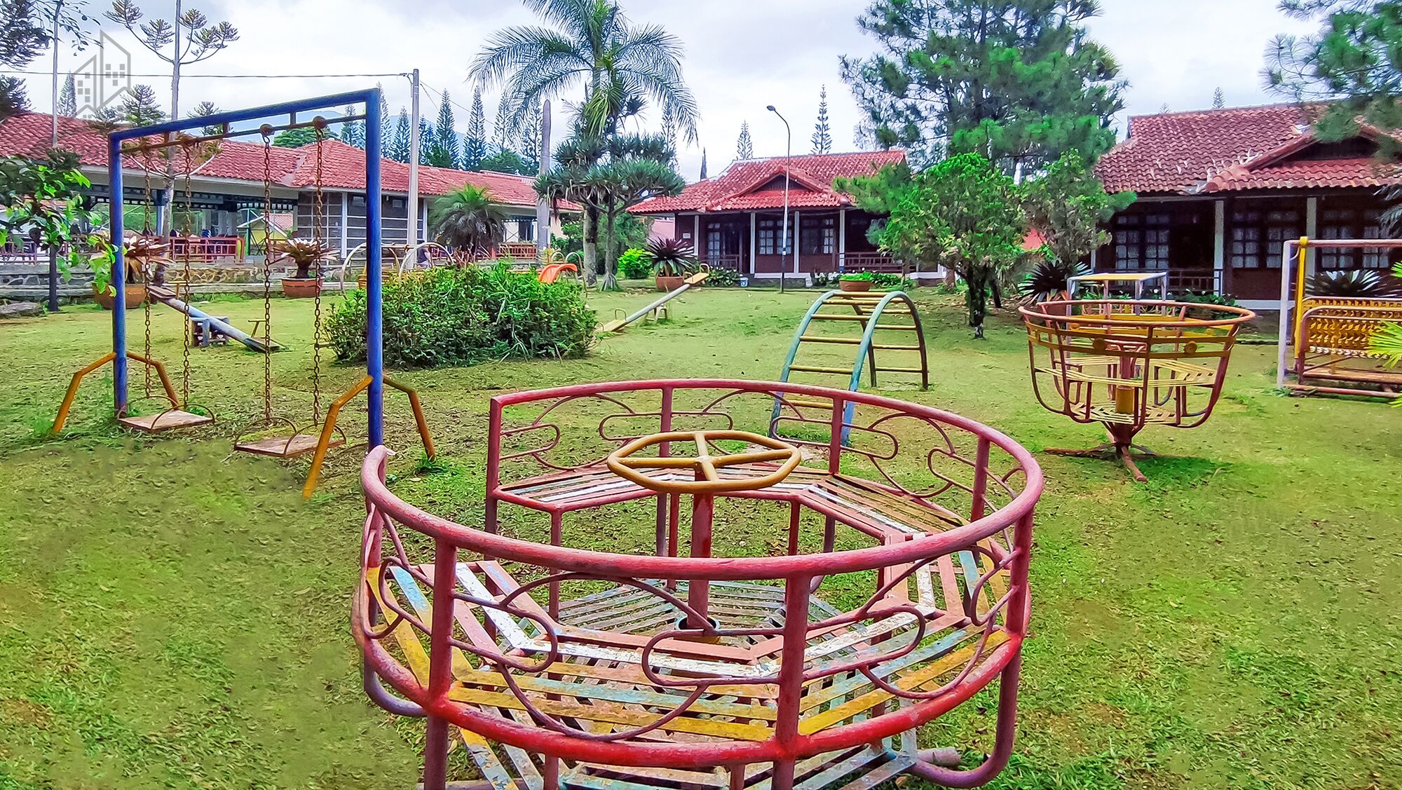 A playground with swings, slides, and a climbing structure.