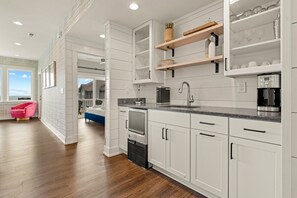 Enjoy cooking in this kitchen with an oven, stainless steel sink, and breakfast bar.