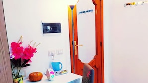 A room with a desk, chair, and a wooden door. - Altea Royale (Naples)