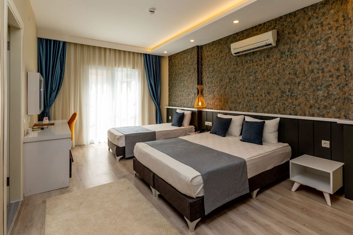 Superior Triple Room | Minibar, desk, laptop workspace, iron/ironing board