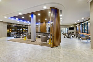 A modern interior with a curved seating area, a wooden partition, and a variety of seating options.