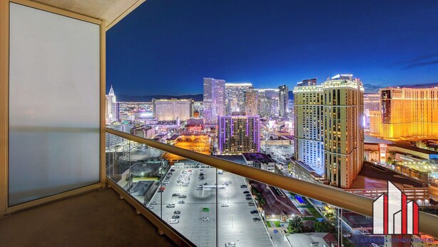 A cityscape view from a high-rise building with a clear night sky. - MGM Signature-29-607 F1 Track & Strip View Balcony (Las Vegas)
