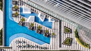 A modern hotel with a rooftop pool, outdoor seating, and a large 'LIV' sign. - Swissotel Clark Philippines (Mabalacat City)