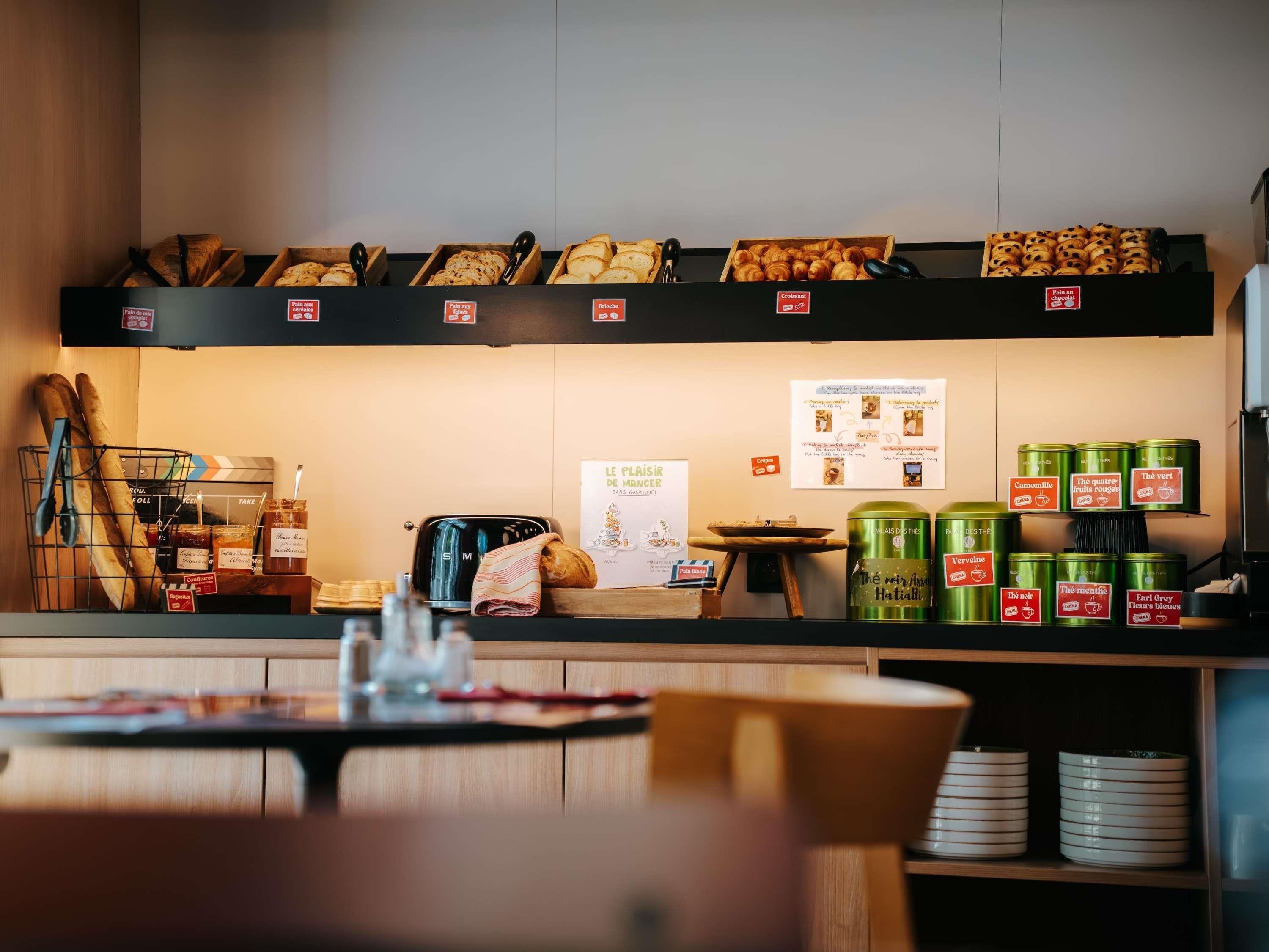 A bakery counter with bread, pastries, and jars of preserves.