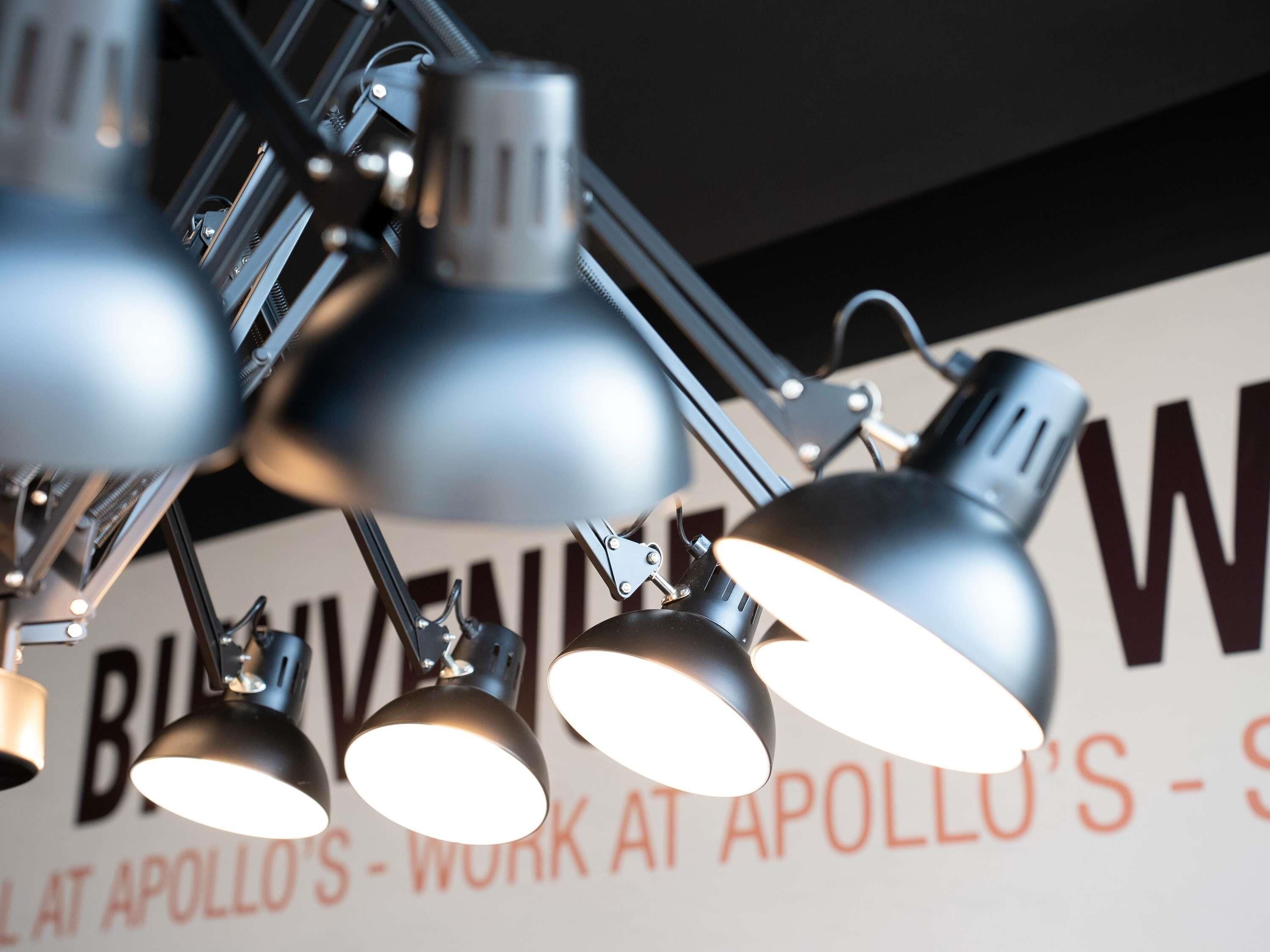 A ceiling-mounted lighting fixture with multiple adjustable arms and lamps.