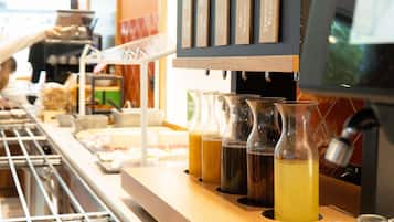A coffee bar with a selection of beverages and a menu board displaying drink options.