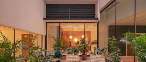 A spacious indoor area with seating, potted plants, and a view of the interior.