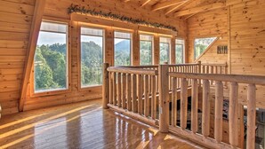 A wooden cabin with a balcony, large windows, and a view of the forest. - Cozy Mountain Retreat, Open Concept, 7 Min To GSM Parkway, 5Br/5Ba, King Beds, (Sevierville)