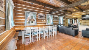 A log cabin interior with a dining area, bar seating, and a TV. - Horni Marsov Khk320 in Horn Mar ov (Horni Marsov)
