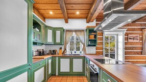 A kitchen with green cabinets, a wooden countertop, and a tiled floor. - Horni Marsov Khk320 in Horn Mar ov (Horni Marsov)