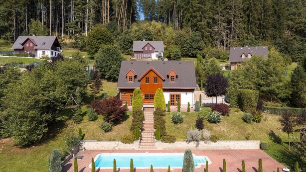 A large house with a swimming pool, surrounded by trees and a hilly landscape. - Villa Pool Stupna Ksa450 (Vidochov)