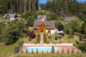 A large house with a swimming pool, surrounded by trees and a hilly landscape. - Villa Pool Stupna Ksa450 (Vidochov)