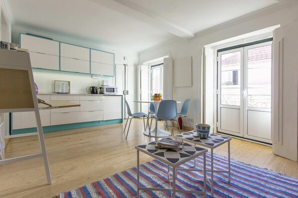 Enjoy a minimalist retreat with a fully equipped kitchen, dining area, and balcony offering a view.