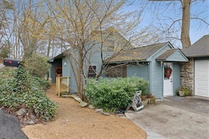 A residential property with a front yard, a mailbox, and a garage.