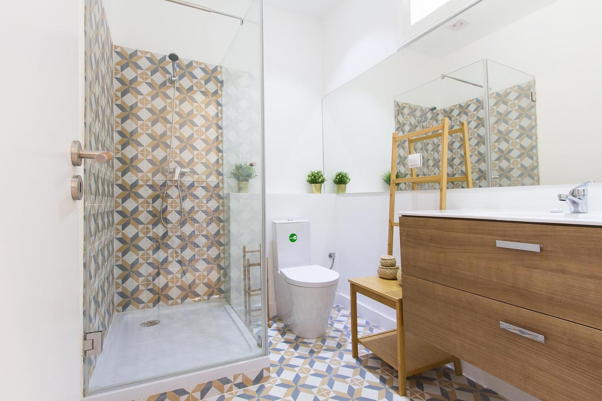 Une salle de bain avec douche, toilettes et lavabo.