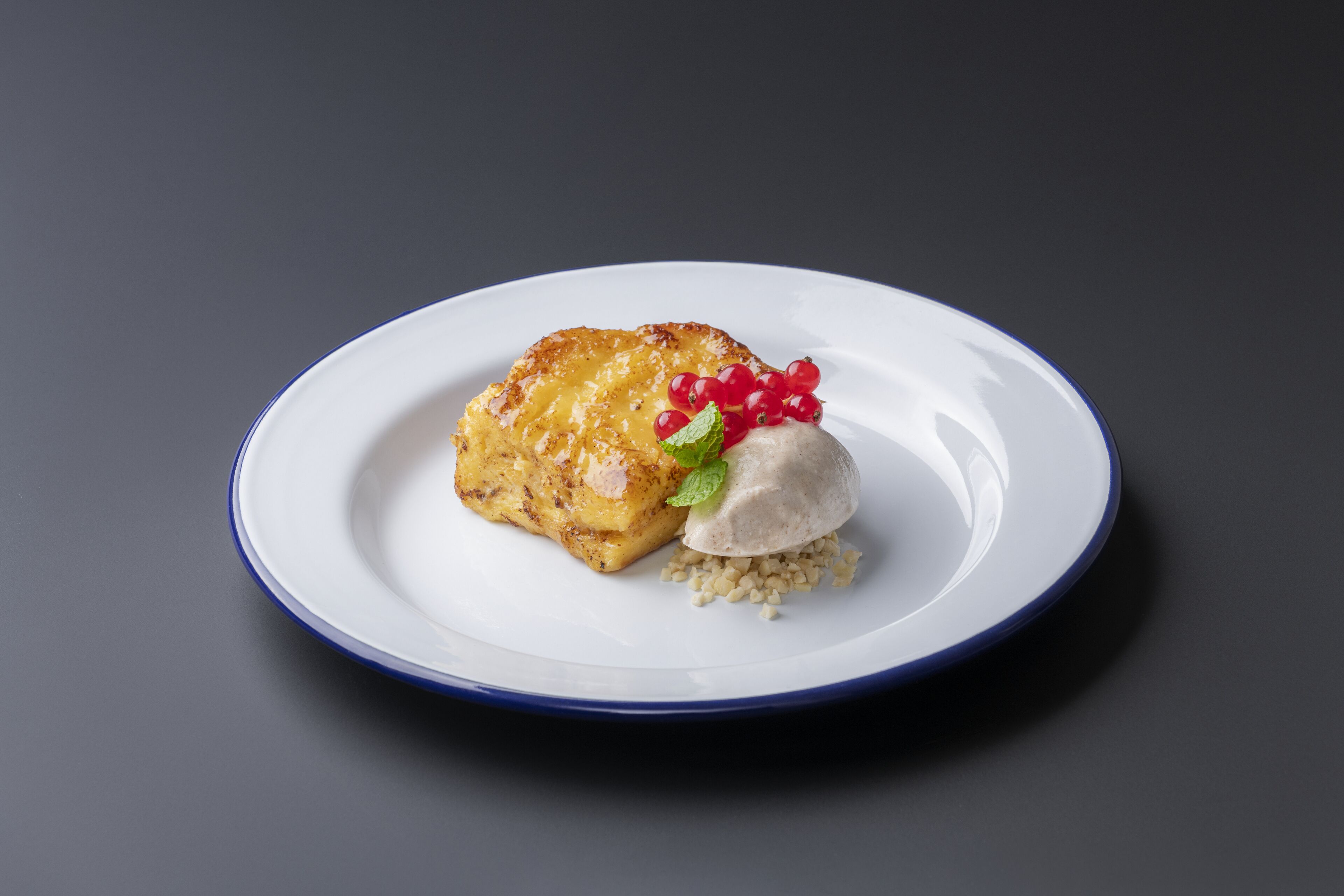 A plate with a piece of food and a scoop of ice cream.