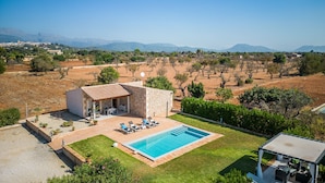 A villa with a swimming pool, outdoor seating, and a view of the countryside. - Finca in Mallorca El Rafal de Son Alberti with pool (Buger)