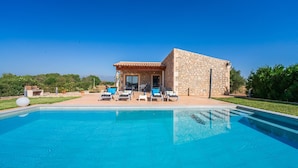 A stone building with a pool, lounge chairs, and a patio area. - Finca in Mallorca El Rafal de Son Alberti with pool (Buger)